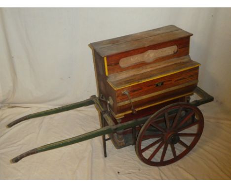 An unusual Spanish mini monkey barrel organ by Faventia marked "Vicente Llinares Faventia Barcelona" 21½" long on painted woo