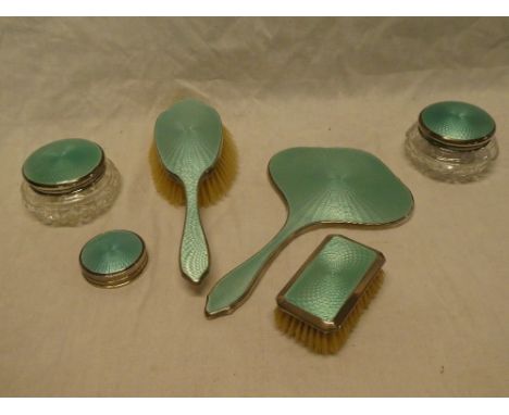 A George V silver and green enamelled dressing set comprising hand mirror, hairbrush, clothes brush, pair of silver mounted g