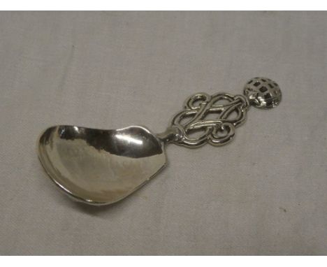 A George V silver caddy spoon with pierced and decorated handle, London marks 1932