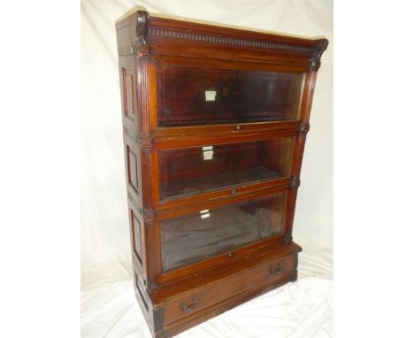 A good quality Globe Wernicke &amp; Co Ltd. mahogany three tier stacking bookcase with base drawer and sliding glazed fronts,