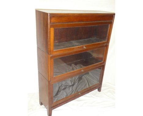 A Globe Wernicke-style mahogany three tier stacking bookcase with sliding glazed fronts, 34" wide