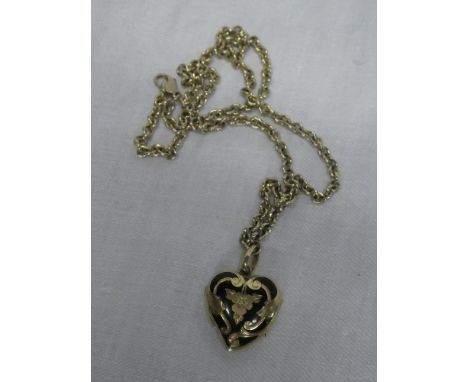 A 9ct gold mounted heart-shaped locket pendant with black enamel and floral decoration with 9ct gold chain