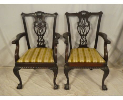 A set of four single and two carver mahogany Chippendale-style dining chairs with pierced vase splat backs and upholstered se