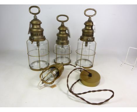 Three brass finish and glass lanterns, battery powered and a similar style heavy brass centre light fitting (4)   Condition R