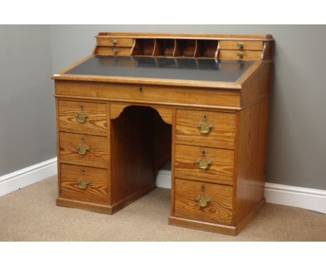 Victorian polished pine desk, sloped hinged lid with leather inset, raised drawers and pigeon holes, six drawers to twin pede