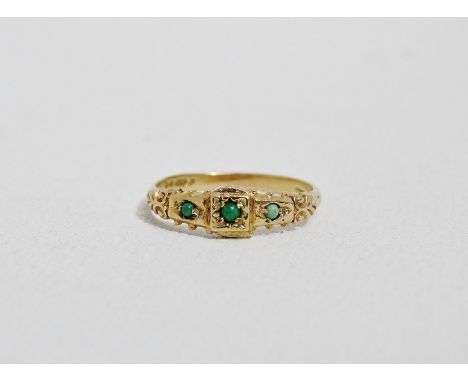 A three stone jade dress ring - the cabachon cut stones in romanesque setting on a 9ct yellow gold band, size P, weight 2g. 