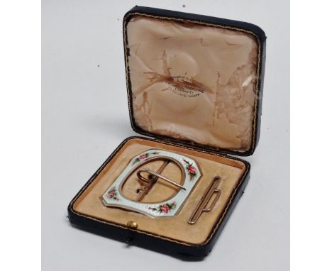 A silver and enamelled buckle - London 1910, Goldsmith &amp; Silversmiths Company, the guilloche white enamel with roses to t