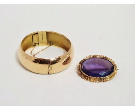 A late 19th century amethyst brooch - the oval faceted stone in a yellow metal foliate frame, length 4cm, together with a yel