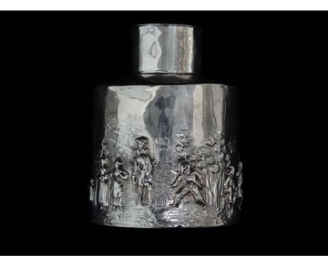 A silver tea caddy - Birmingham 1904, sponsor's mark for Charles Horner, the cylindrical body decorated with a bucolic scene,