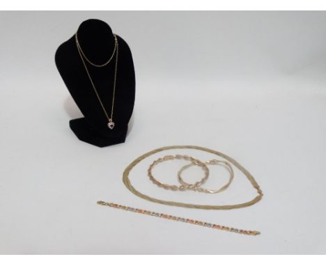 A 9ct yellow gold twisted bangle - together with another 9ct hinged bangle, an Italian 9ct platted gold necklace, tricolour 9