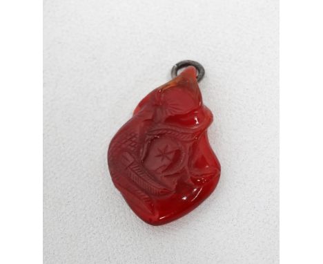 A carved hardstone pendant - possibly jade, decorated with flowers and foliage, height 4cm. 