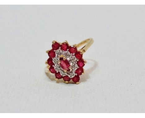 A ruby and diamond dress ring - of stepped navette shape, claw set in a 9ct yellow gold band, size M, weight 2.4g.