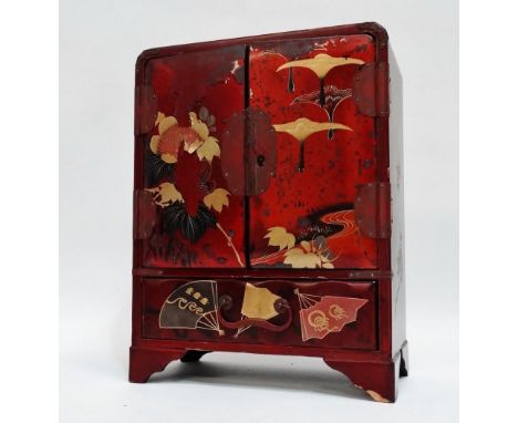 A late 19th century Japanese table cabinet - cinnamon lacquer, with double doors enclosing drawers above a long drawer, on br