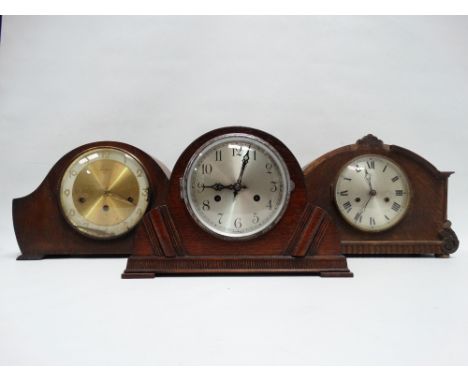 A mid 20th century oak mantel clock - the silvered and brass dial set out in Roman numerals fitted with a three train movemen