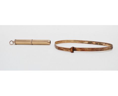 A 9ct yellow gold engine turned toothpick - together with a gold plated bangle. 