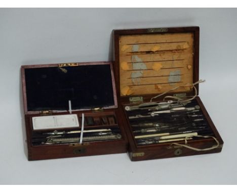 A late 19th century mahogany box of drawing instruments - with a tray of nickel plated equipment with further items below inc