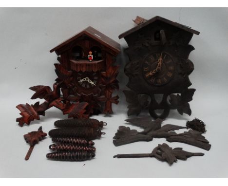 A 20th century German cuckoo clock - in a traditional case with dancing figures on the hour, height 30cm, together with anoth
