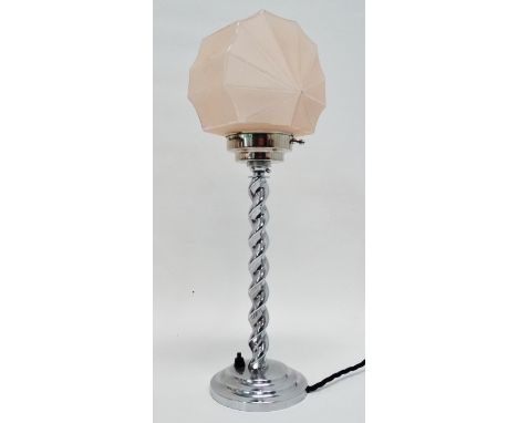 An Art Deco chrome table lamp - the spiral twist support on a circular base with a pink glass sunburst shade, height 47cm.
