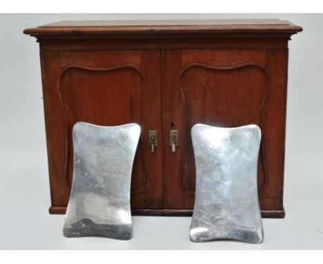 An early 20th century Anglo Indian smoker's cabinet - the shaped panel doors with silver plated plaques bearing gift signatur