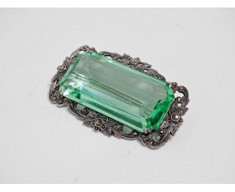 A marcasite brooch - set with a light green faceted paste stone panel, width 5cm. 