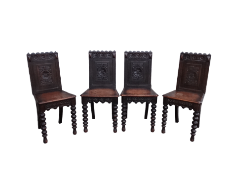 A set of four 17th century style oak hall chairs - The carved panel back above a solid seat with canted corners and raised bo