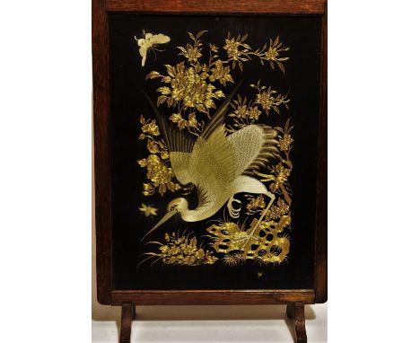 An early 20th century Chinese silk embroidered panel - depicting a crane and butterfly within gilt foliage on a black ground,