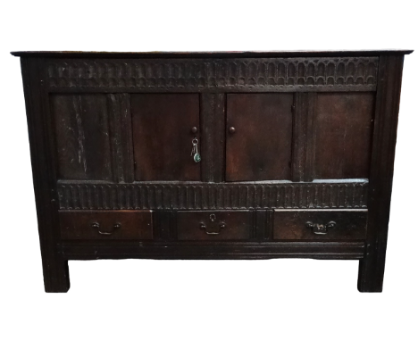 A 17th century and later oak mule chest - the rectangular top above a stop fluted frieze, later panel doors and three apron d
