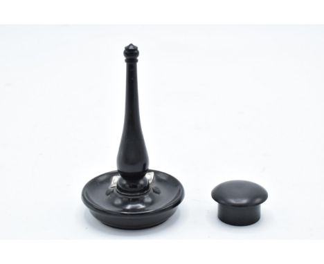 An ebony ring stand with a silver mount (London) together with an ebony circular pill box (2). 11cm tall. In good condition w