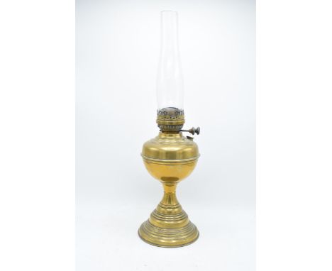 A 20th century brass oil lamp with an associated shade. 32cm tall without shade. 'Best English Make' 