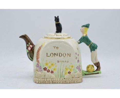 A 1940s novelty ceramic tea pot in the form of Dick Whittington and his cat by Bancroft and Bennett of Burslem. 18cm tall. In