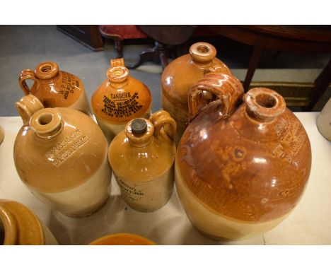 A collection of stoneware jars and flagons to include R Ross of Barbraville, Davies Haynes and Doddl, Tansers, T Watts of Far