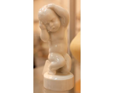Royal Copenhagen ceramic glazed putti figure. H: 10 cm