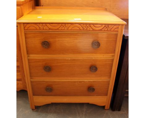 Light oak chest of three drawers with carved panel