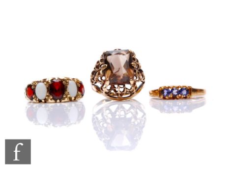 Three 9ct hallmarked stone set rings to include a three stone lolite and an opal and garnet five stone etc, total weight 9.5g