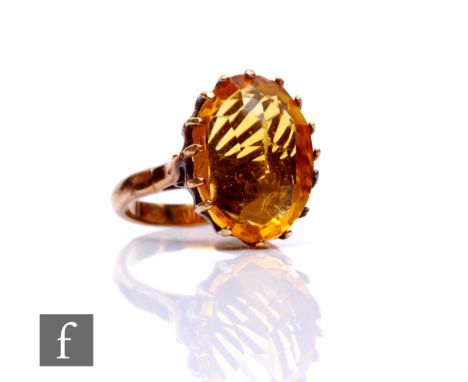 A 9ct single stone citrine ring, claw set oval stone to plain shoulders, weight 6g, ring size M. 