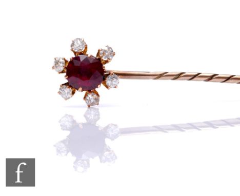 An early 20th Century ruby and diamond set stick pin, central ruby, length 10mm, within a border of six old cut, claw set dia