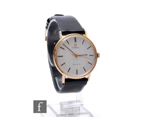 A 9ct hallmarked Omega manual wind Geneve wrist watch, gilt batons to a silvered circular dial, case diameter 34mm, to a blac