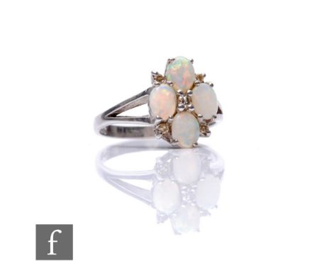 A 9ct hallmarked white gold nine stone opal and diamond cluster ring, claw set stones to split shoulders, weight 2.7g, ring s