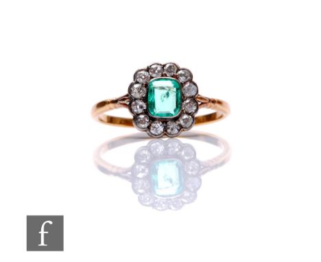 A 9ct emerald and diamond cluster ring, emerald cut central emerald to a border of twelve transitional cut diamonds, length o