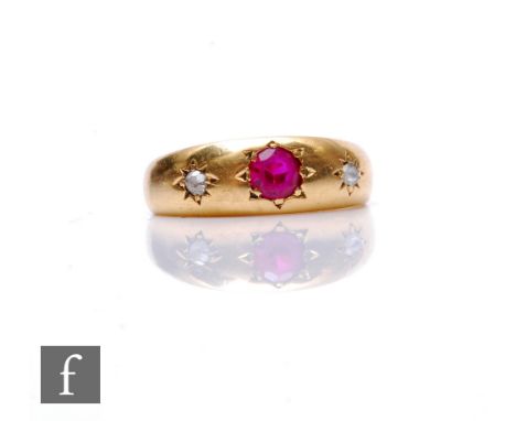 An 18ct hallmarked diamond and red spinel three stone ring, gypsy set stones to a plain shank, weight 3.9g, ring size J, Birm