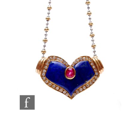 A 14ct ruby, lapis lazuli and diamond set cushioned heart shaped pendant suspended from a 14ct yellow and white gold chain, t