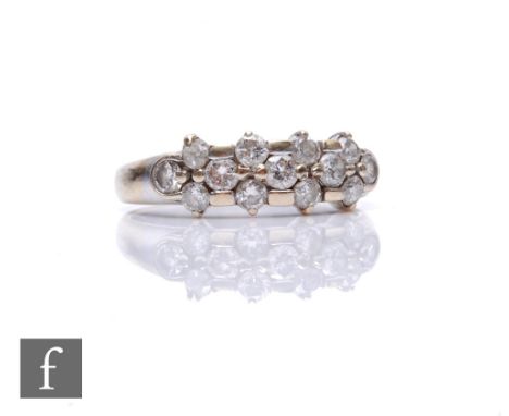 An 18ct white gold three row diamond ring comprising thirteen individually claw set brilliant cut stones, weight 3.3g, ring s