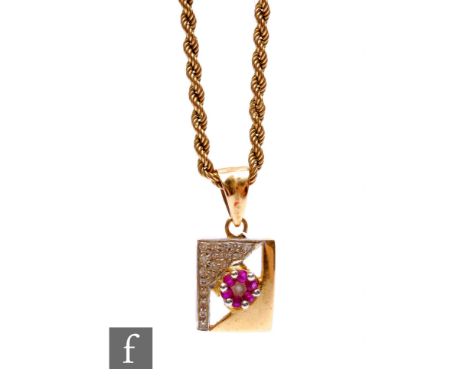 An 18ct ruby and diamond rectangular pendant, weight 2.45g, suspended from a 9ct rope twist chain, weight 2g. 