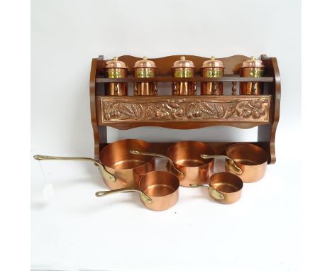 A graduated set of 5 French copper and brass saucepans, largest 18.5cm, together with a wall-mounted shelf with embossed copp
