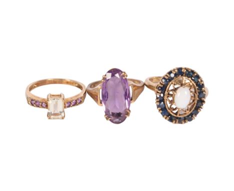 A 9ct sapphire and opal set dress ring, a 9ct gold amethyst and stone set dress ring, and an unmarked gold and amethyst set r