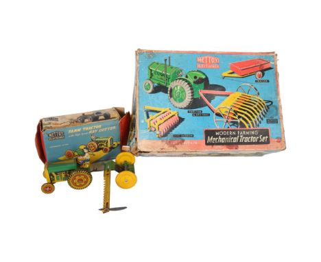 Mettoy Playthings, a boxed farm tractor with high speed hay cutter, model ref. 6435/77, appears complete and in original box,