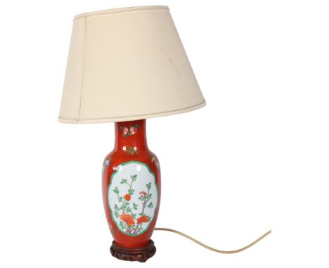An Oriental ceramic table lamp with orange ground, on wooden stand, with shade, H53cm overall 