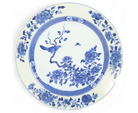 A Chinese blue and white "Bird and Blossom" porcelain plate, Kangxi, painted depicting bird and butterfly in blossom tree, di