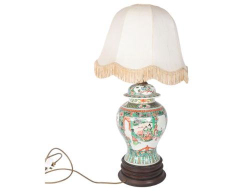 An Oriental ceramic famille vert table lamp, on wooden stand, with figure decorated panels, and shade, H65cm overall 