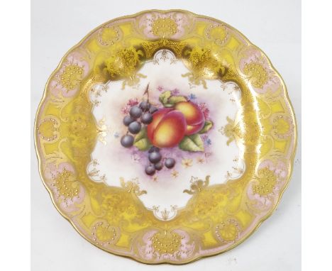 A Royal Worcester cabinet plate, decorated to the centre with a panel of hand painted fruit, by R Lewis, to a shaped yellow a